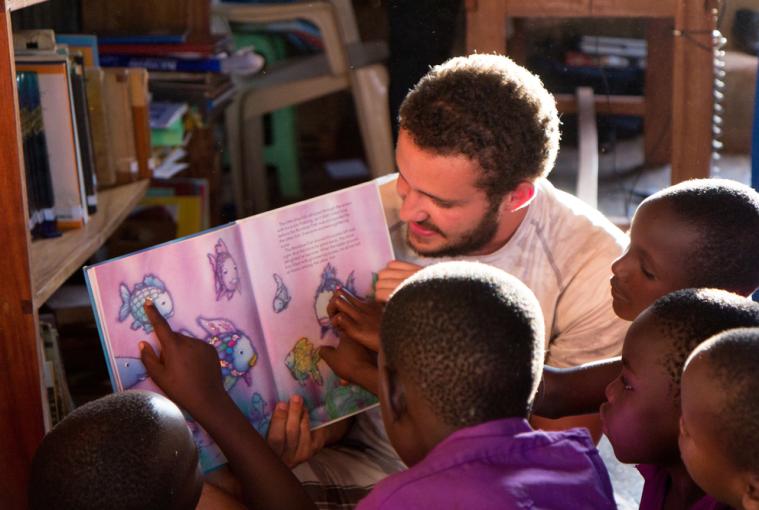 Teacher reading book to young children