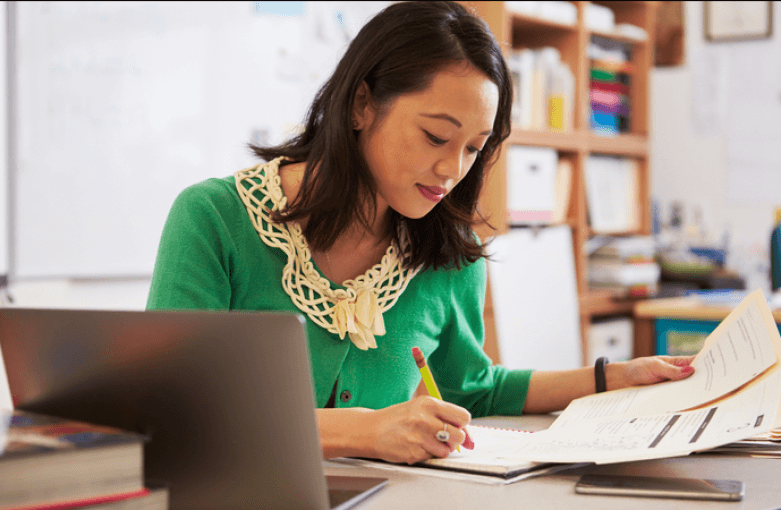 Take the Plunge! JC English teacher planning at desk 